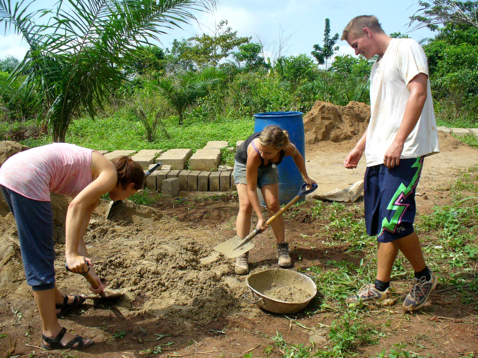A group of volunteers participate in community building exercises during their buidling volunteer work in Ghana with Projects Abroad. Projects Abroad volunteers can be seen participating in preparing the building site during their building volunteer work in Ghana.